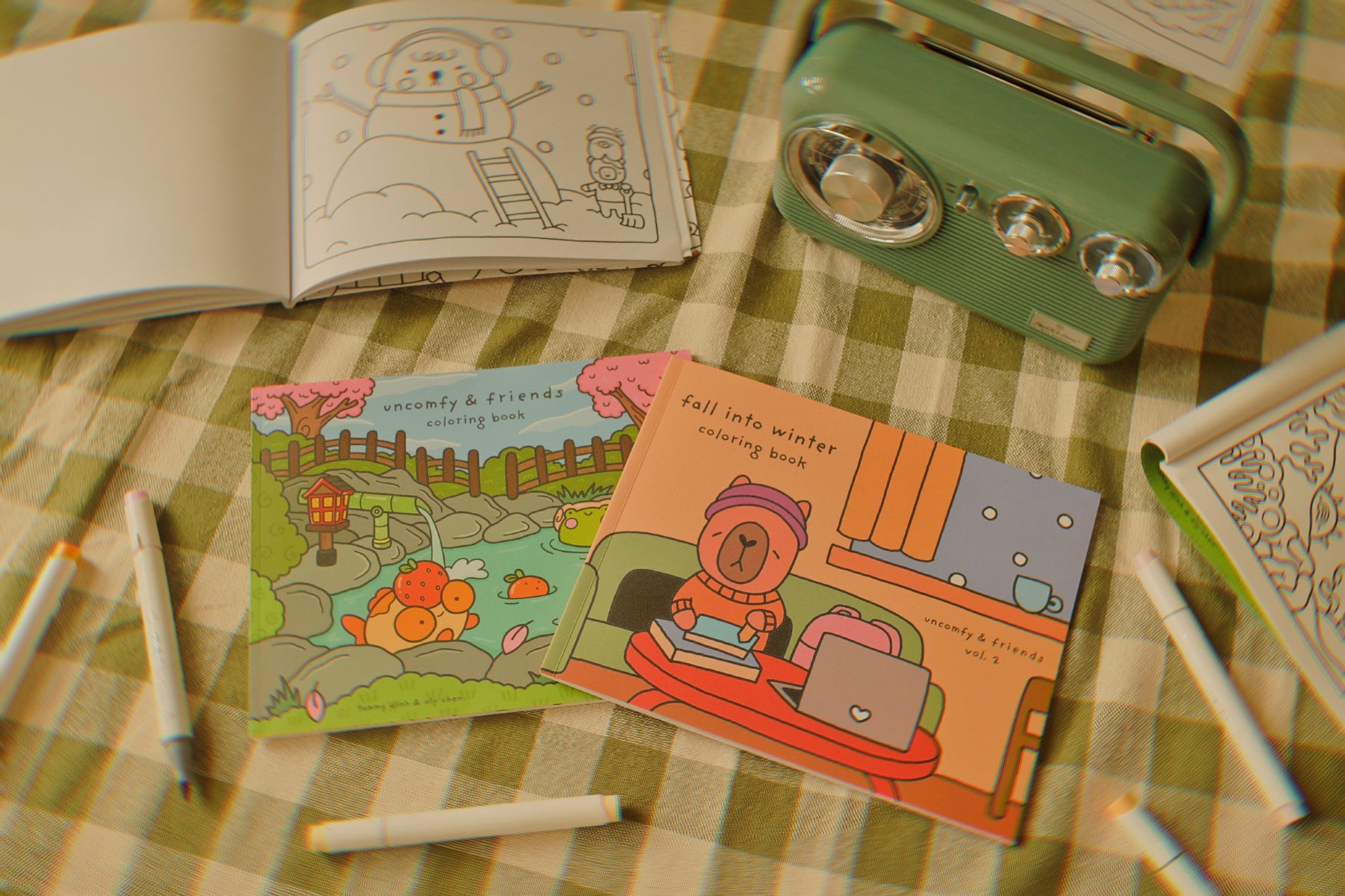 Coloring books and crayons on a checkered tablecloth